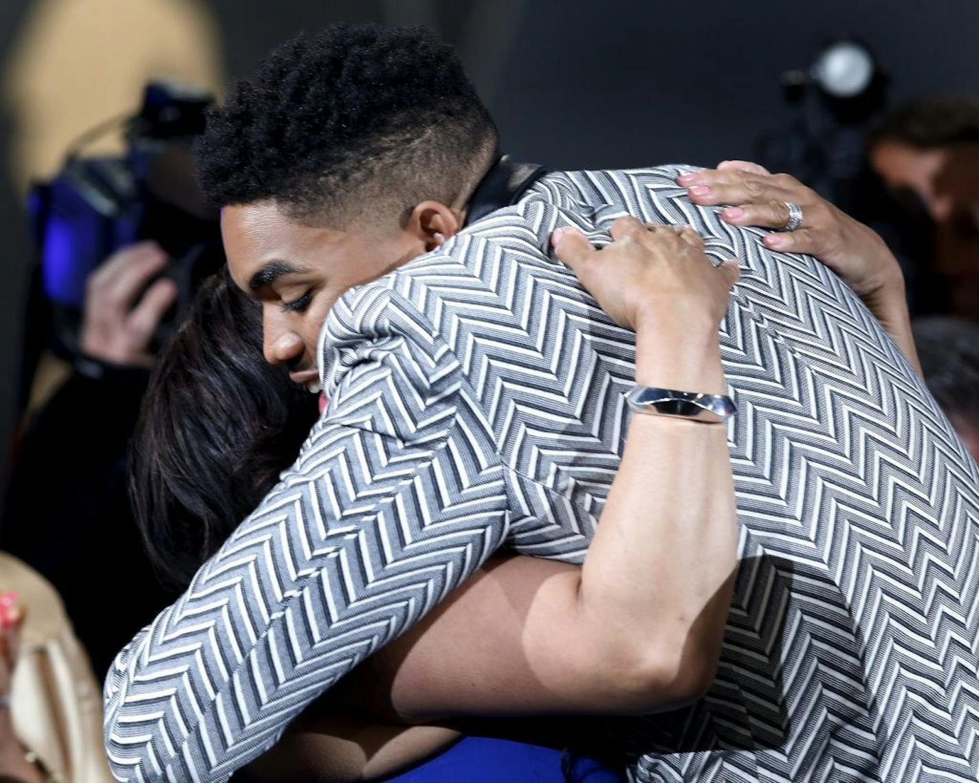 Karl-Anthony Towns hugs friends and family after the Minnesota Timberwolves selected him with the first pick during the NBA basketball draft, Thursday, June 25, 2015, in New York.