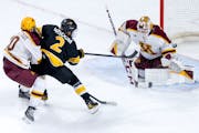 Zaccharya Wisdom (2) of Colorado College gets the puck past Minnesota goalie Justen Close (1) for a goal in the third period Sunday, January 7, 2024, 