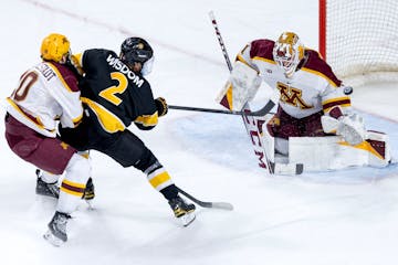 Zaccharya Wisdom (2) of Colorado College gets the puck past Minnesota goalie Justen Close (1) for a goal in the third period Sunday, January 7, 2024, 