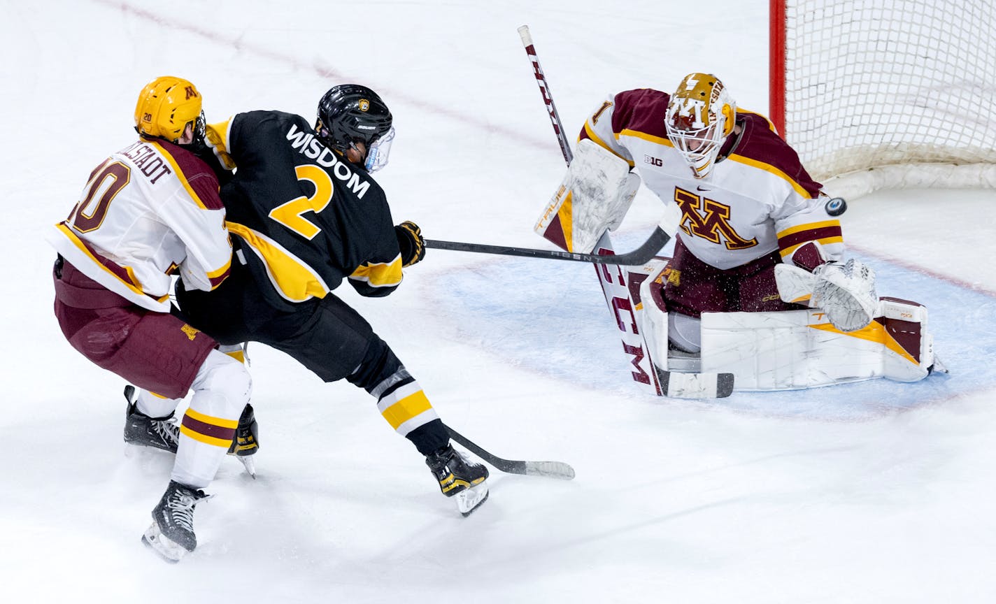 Zaccharya Wisdom (2) of Colorado College gets the puck past Minnesota goalie Justen Close (1) for a goal in the third period Sunday, January 7, 2024, at 3M Arena at Mariucci in Minneapolis, Minn. ] CARLOS GONZALEZ • carlos.gonzalez@startribune.com