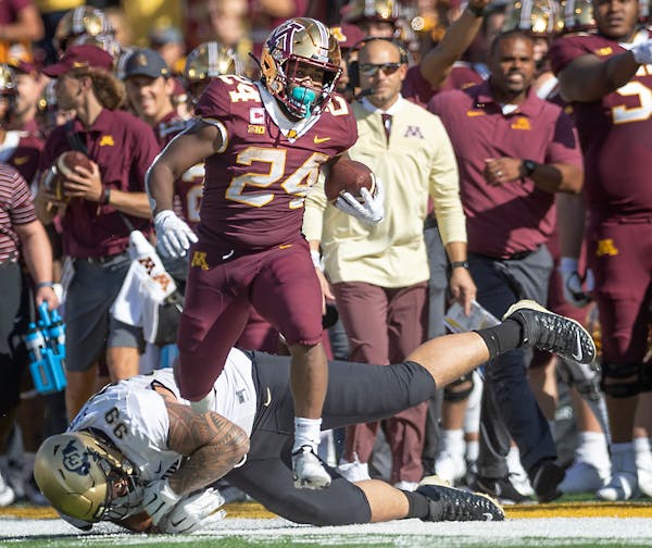 Gophers running back Mohamed Ibrahim broke from the grasp of Colorado’s defensive lineman Jalen Sami (99) in the second quarter on Saturday against 