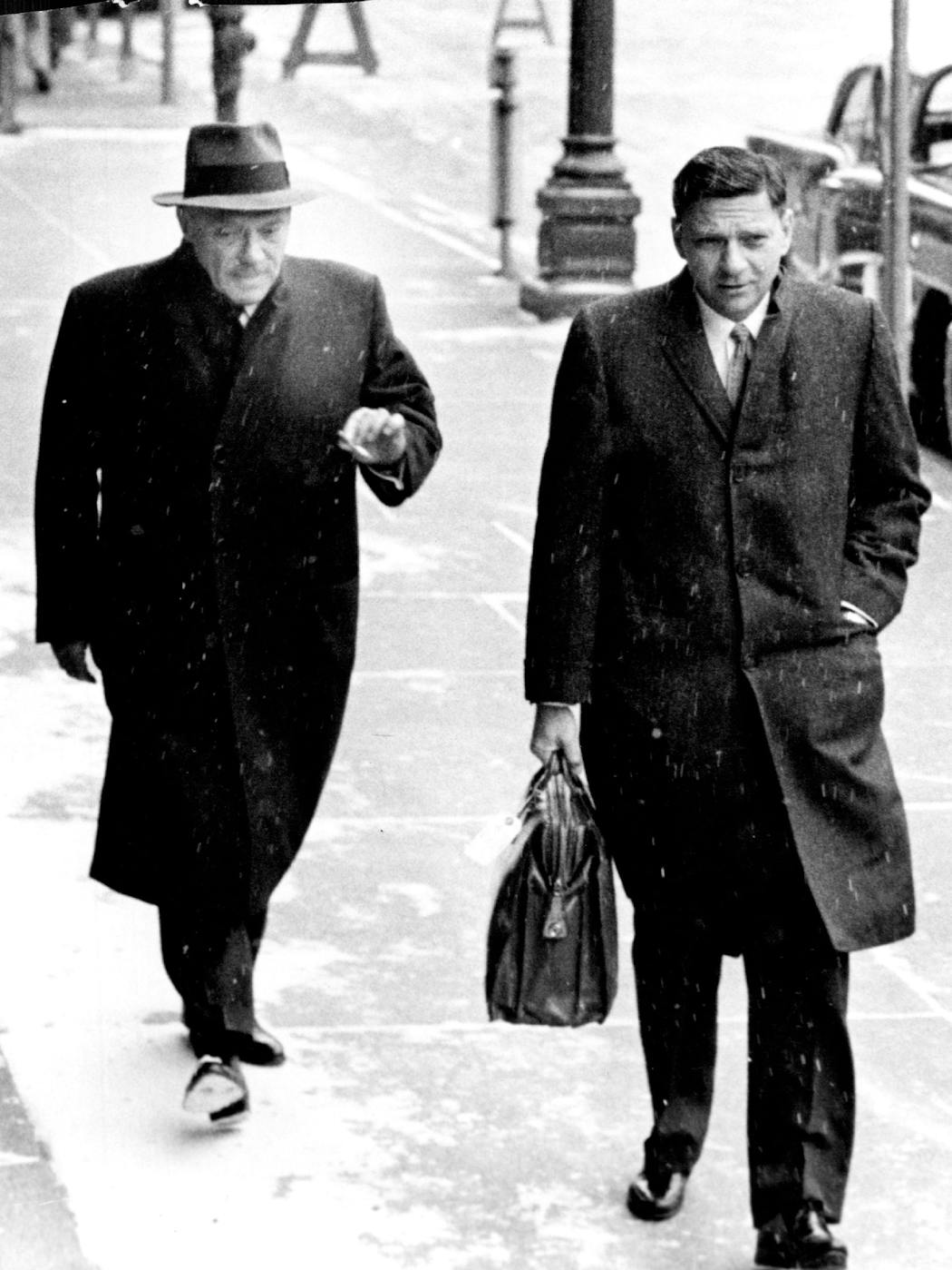 Isadore Blumenfeld walked with his attorney during proceedings related to the trafficking charges against him in 1960.
