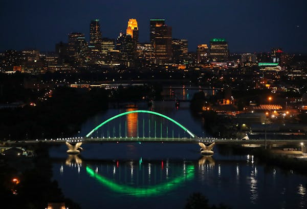 A view of downtown Minneapolis from north of the Lowry Avenue Bridge in 2017, when several buildings were lit green for the Star Tribune’s 150th ann