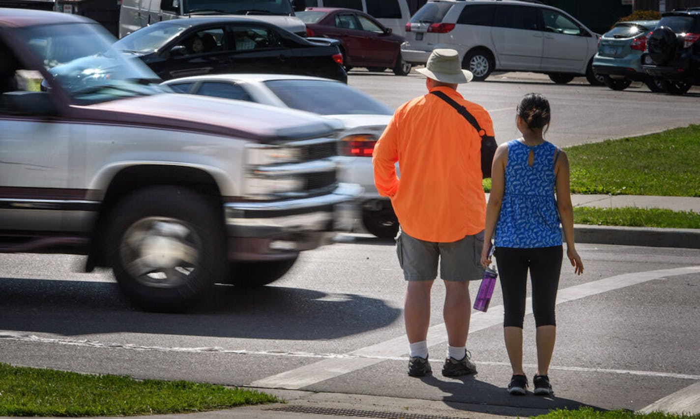 A maroon and silver truck drove through the marked crosswalk in front of pedestrian volunteers Dave Passiuk and Nelsie Yang. It was pulled over seconds later by St. Paul Police. ] GLEN STUBBE * gstubbe@startribune.com Wednesday, June 8, 2016, Volunteers from neighborhood groups working with StopForMe.org entered a marked pedestrian crosswalk at Johnson Parkway and Ames Ave on the East Side of St. Paul. If the vehicles violated the law they were pulled over by St. Saul Police. A day after yet another pedestrian was killed after being hit by a car while crossing the street, St. Paul Police were once again trying to get motorists to slow down, pay attention and yield to people in crosswalks. So far, motorists don't seem to be getting the message. In 22 previous "Stop For Me" campaign events this year — in which volunteers wearing safety vests cross the street and nearby squad cars stop and ticket drivers — police made764 stops, issued 341 citations for failure to yield to pedestrians, wrote 257 tickets for other offenses and issued 12 warnings. "I think it's just that society feels entitled," police spokesman Steve Linders said when asked what is going on in St. Paul. "People are just going around doing what they want whenever they want." EDS, Nelsie is cq