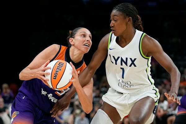 Phoenix Mercury guard Diana Taurasi, left, drives against Minnesota Lynx forward Diamond Miller (1) during the second half of a WNBA basketball game T