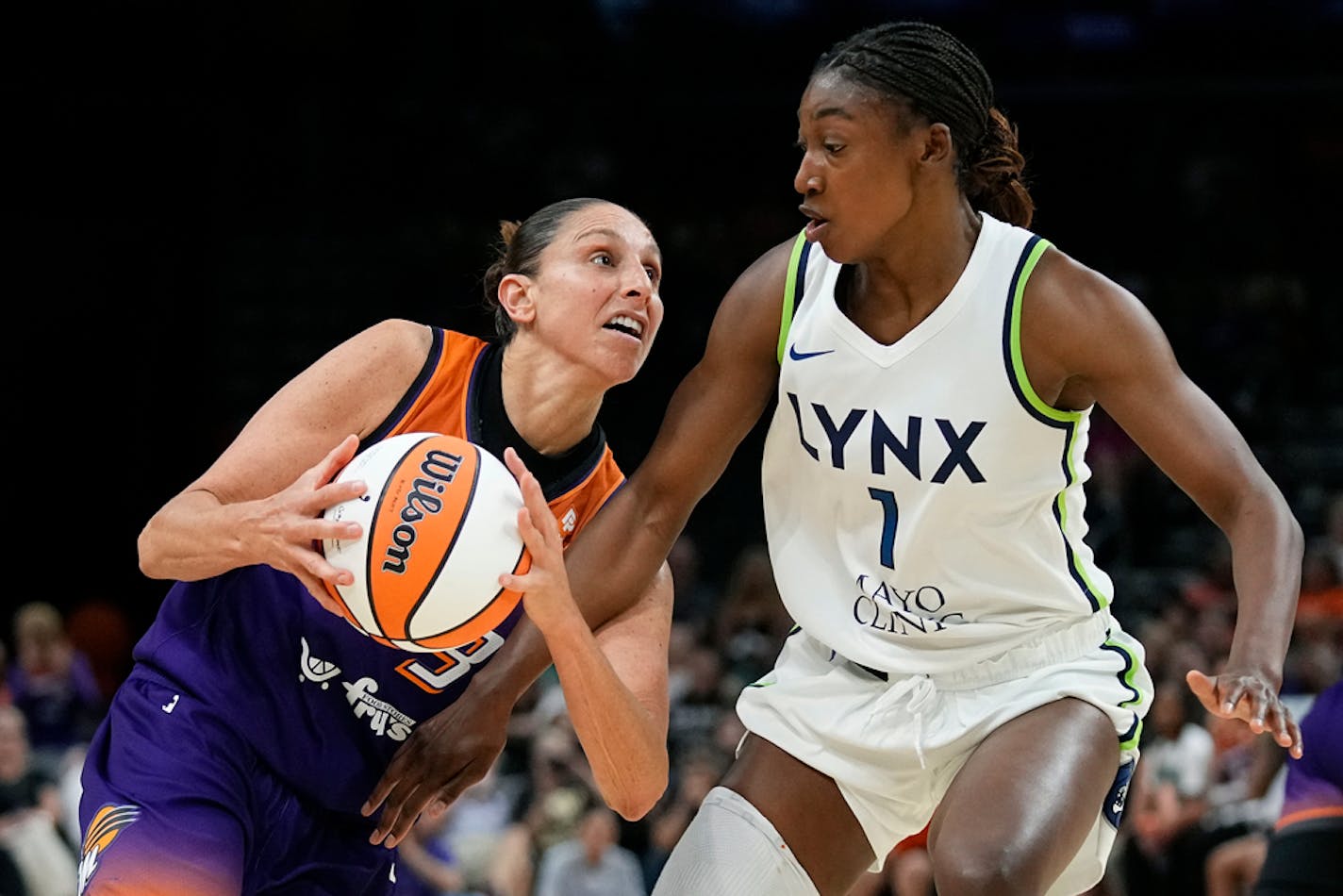 Phoenix Mercury guard Diana Taurasi, left, drives against Minnesota Lynx forward Diamond Miller (1) during the second half of a WNBA basketball game Thursday, May 25, 2023, in Phoenix. The Mercury won 90-81. (AP Photo/Ross D. Franklin)