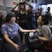 Emily Snow prepared to tattoo the quote "she persisted" on Chelsea Brink Tuesday afternoon at Brass Knuckle Tattoo Studio. Brink is the designer who c