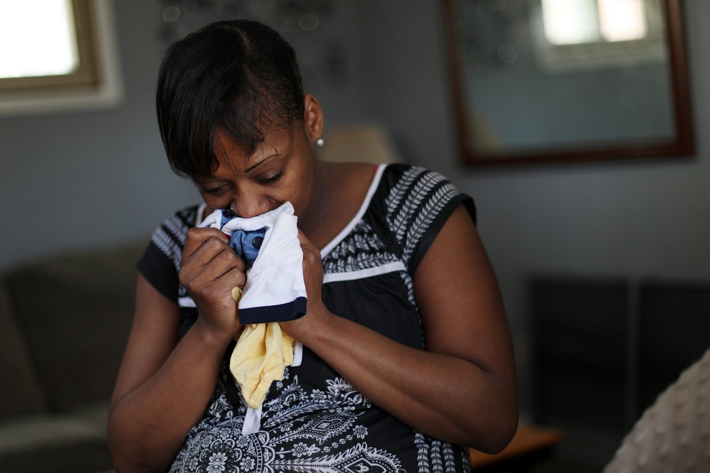 DeClara Tripp, whose son Zhakari was taken by county child protection services and placed in foster care back in 2015 after being admitted to the hospital for an injury, held an outfit she says still smells like her son as she sat for a portrait at her home Friday.