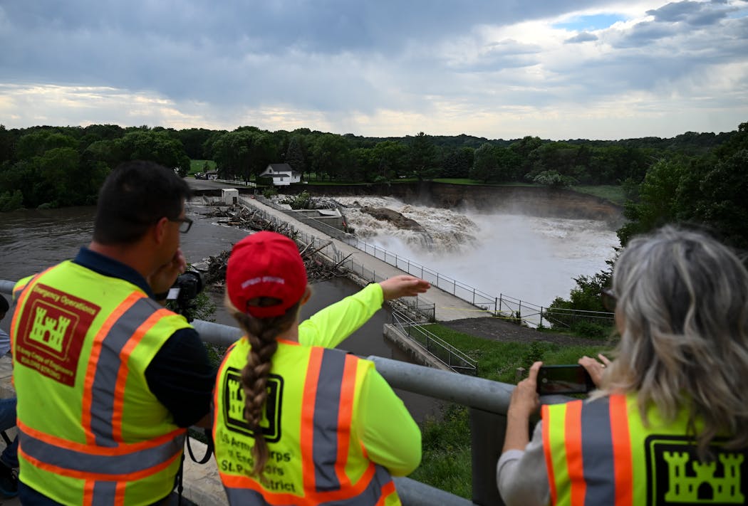 Workers with the U.S. Army Corps of Engineers discuss the Rapidan Dam failure situation Monday near Mankato. 