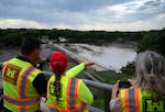 Workers with the Army Corps of Engineers discuss dam safety on Monday above the Rapidan Dam in Mankato.