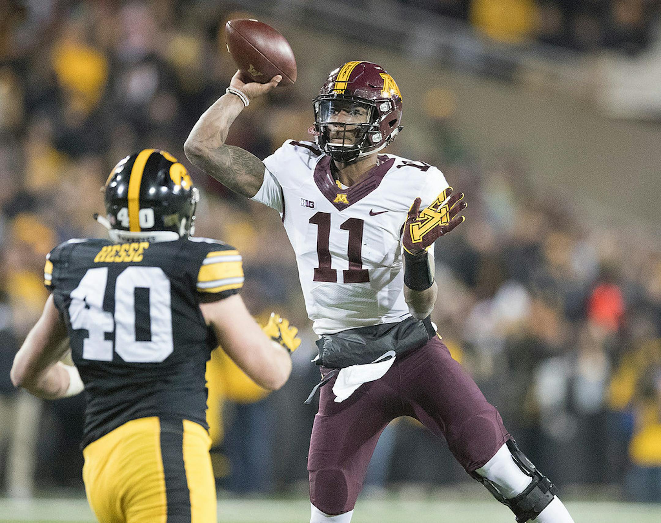 Demry Croft, throwing over Iowa's Parker Hesse, completed only nine of 29 passes for 139 yards Saturday night.