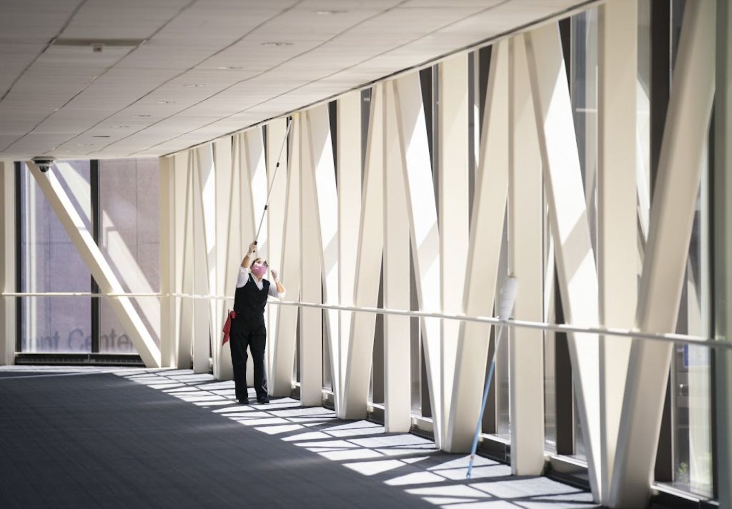 A maintenance worker dusted in an otherwise deserted skyway over S. 3rd Avenue in Minneapolis on Tuesday afternoon.