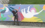 Artist Jennifer Davis paints a mural at Hai Hai.