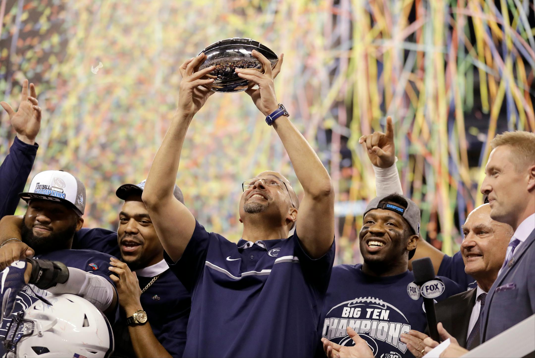 Penn State head coach James Franklin holds the trophy after Penn State won the Big Ten championship NCAA college football game Saturday, Dec. 3, 2016, in Indianapolis. Penn State won 38-31. (AP Photo/Michael Conroy)