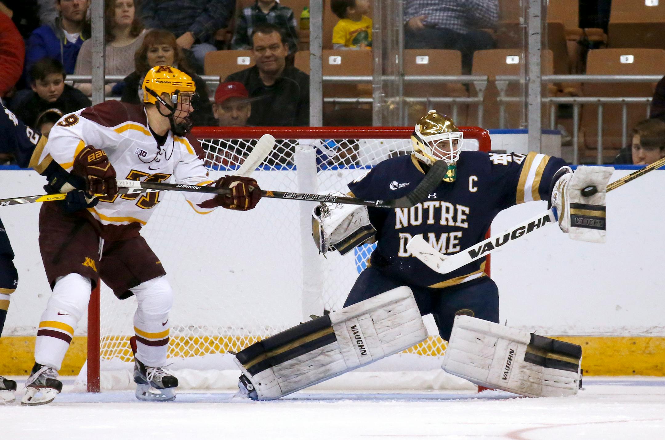 Notre Dame's goalie Cal Petersen makes a blocker save as Minnesota's Mike Szmatula (9) looks for a deflection during the first period of an NCAA regional men's college hockey tournament game, Saturday, March 25, 2017 in Manchester, N.H. (AP Photo/Mary Schwalm)