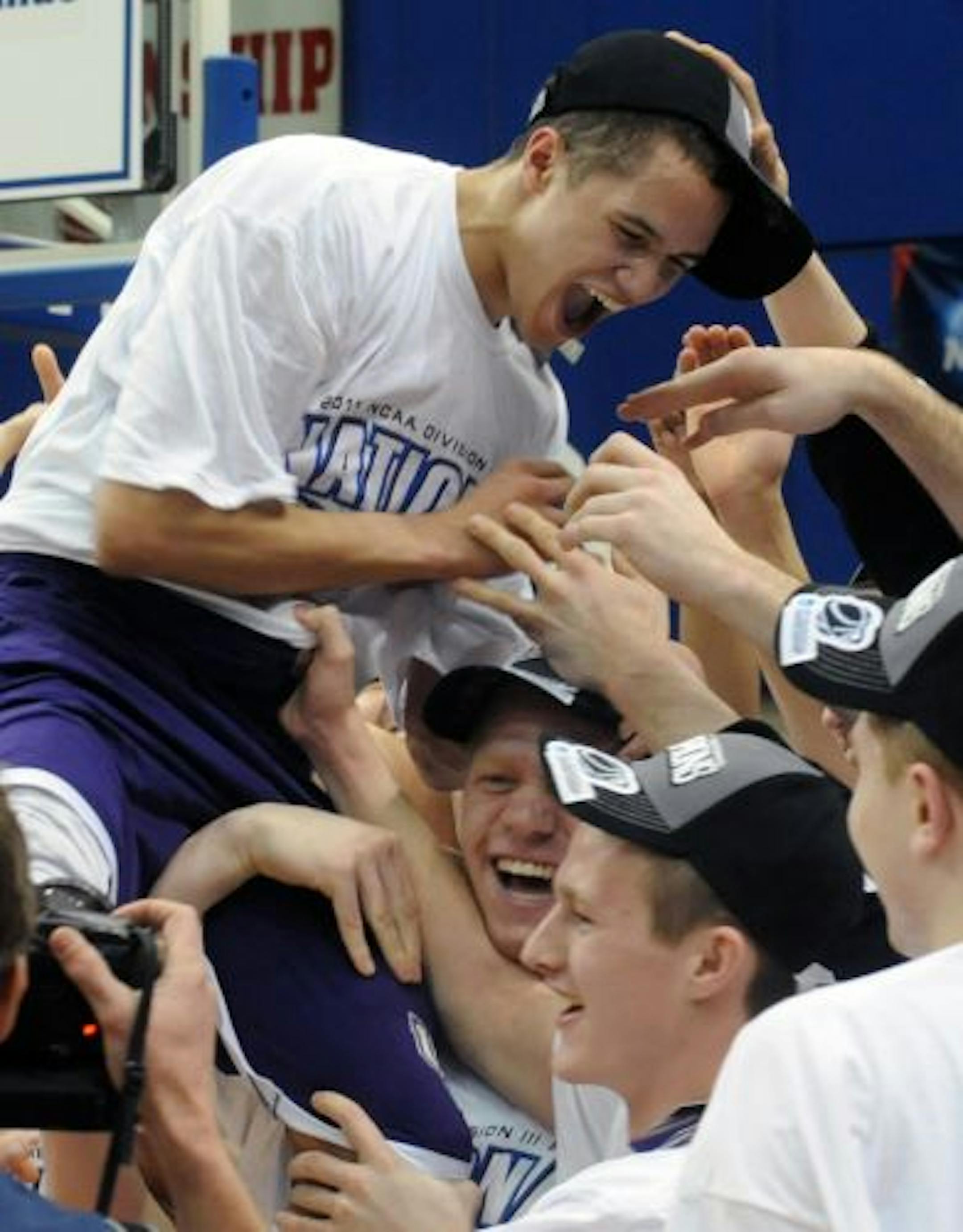 St. Thomas player Tyler Nicolai is hoisted by teammates after being named the most valuable player as they celebrate after beating Wooster 78-54 in the NCAA Division III Championship college basketball game at the Salem Civic Center in Salem, Va., Saturday March 19, 2011.