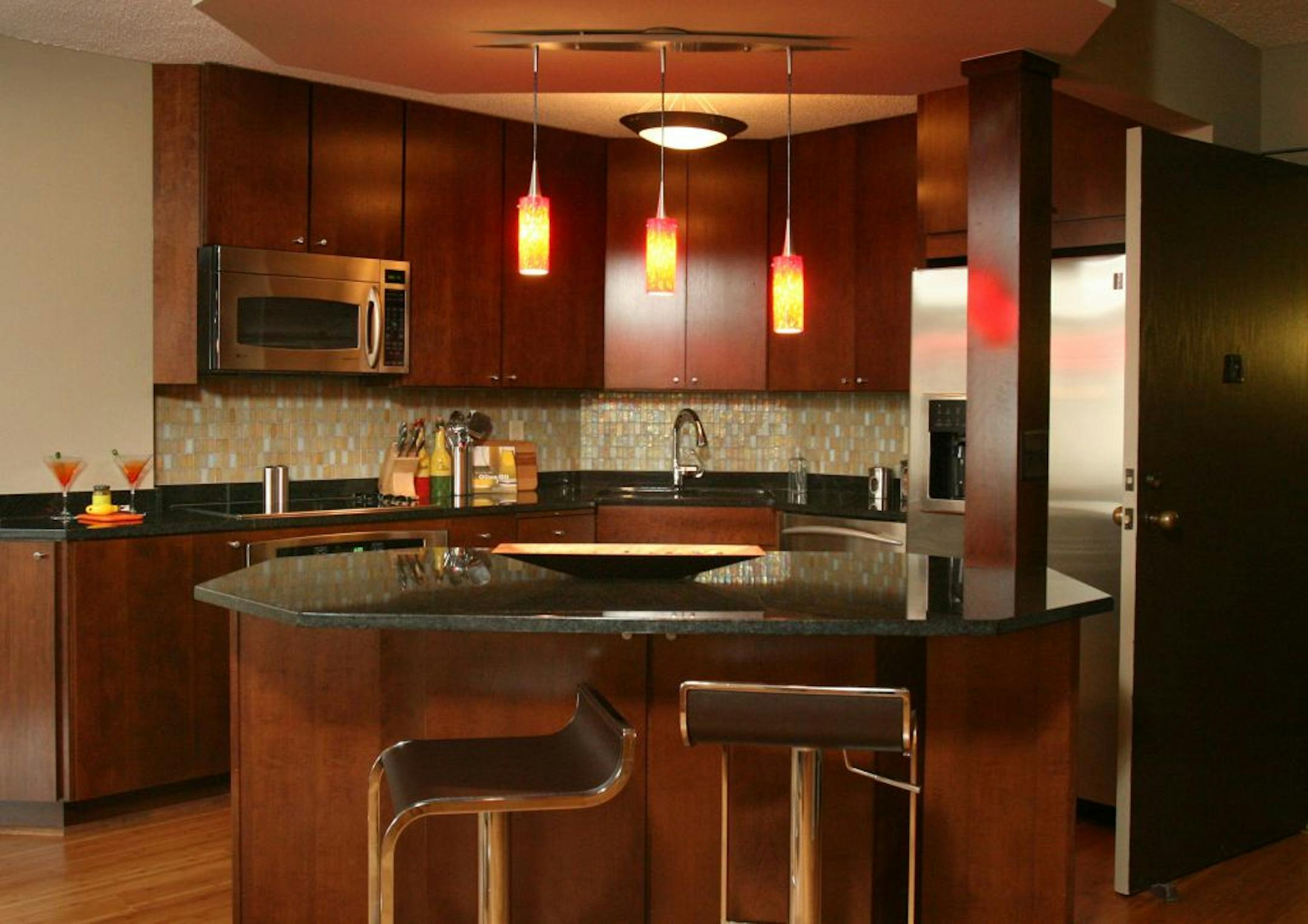 COND0914 Star Tribune photo/Tom Wallace Riverwest hired Keller to design and decorate several units. Keller specified custom touches throughout, including a commissioned zebra-wood cabinet and upholstered headboard for the master bedroom and an iridescent-glass backsplash in the kitchen. The kitchen at Riverwest.