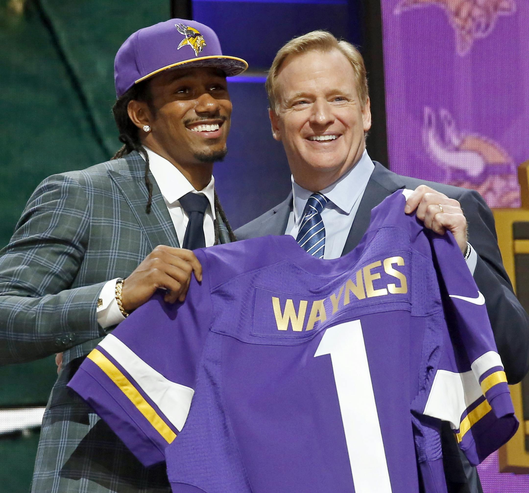 Michigan State defensive back Trae Waynes poses for photos with NFL commissioner Roger Goodell after being selected by the Minnesota Vikings as the 11th pick in the first round of the 2015 NFL Draft, Thursday, April 30, 2015, in Chicago. (AP Photo/Charles Rex Arbogast)