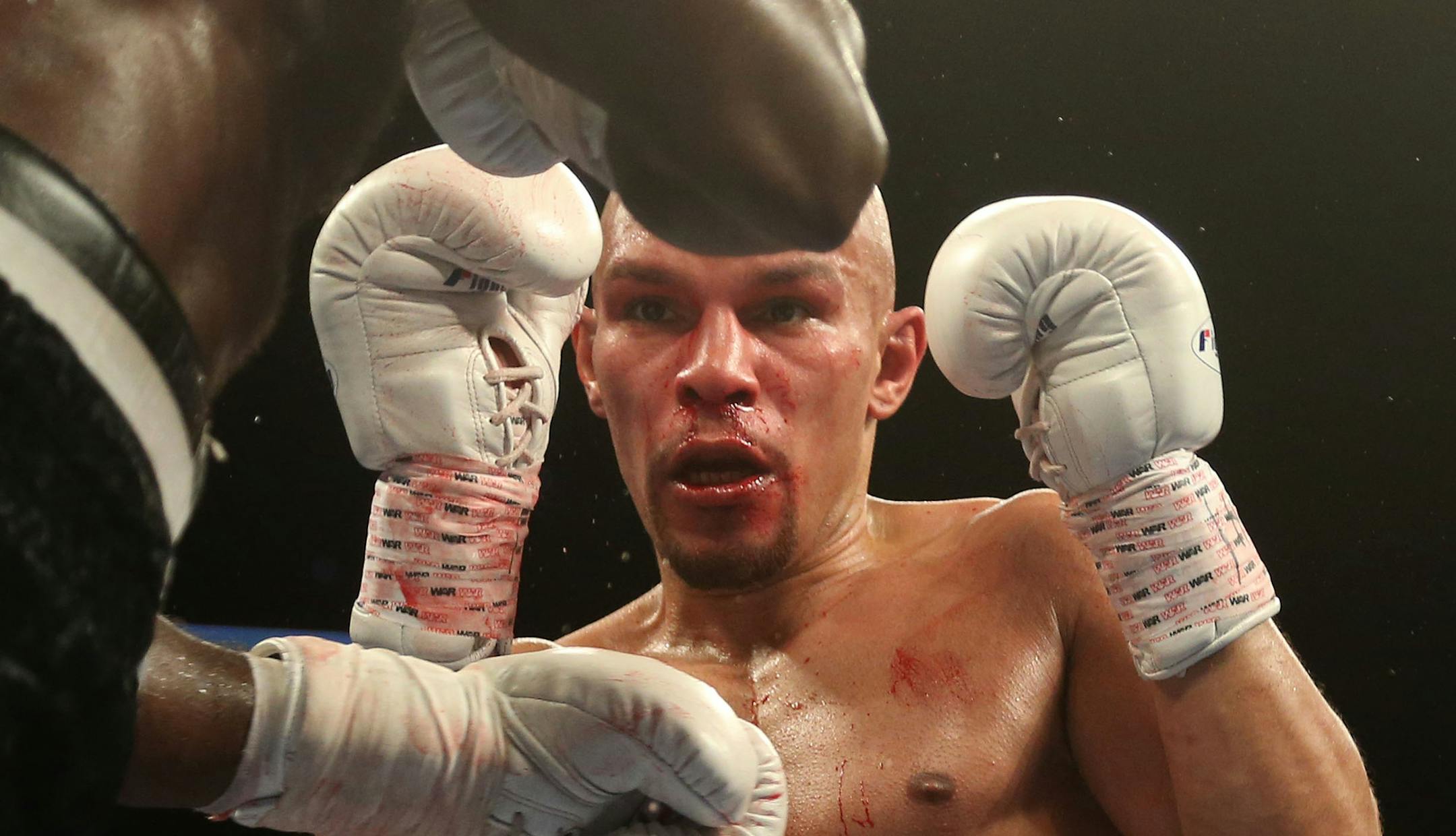 USBA Middleweight Champion Caleb Truax, of Osseo, Minnesota watched the hands of Ossie Duran aka - The Ghanaian Gladiator during a semi final fight at Target Center in Minneapolis Friday, January 3, 2014. The bout ended in a tie 95-95. ] (KYNDELL HARKNESS/STAR TRIBUNE) kyndell.harkness@startribune.com