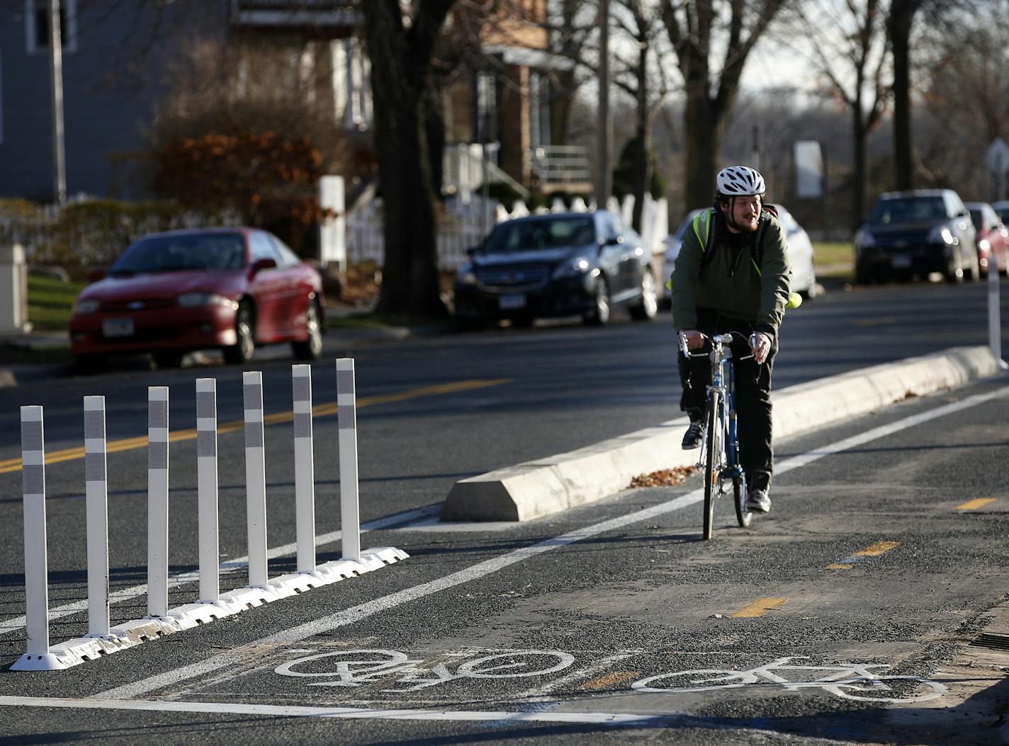 Michael Duren, 23, of Minneapolis rode along a bike trail on Oak St. SE near the University of Minnesota in Minneapolis. ] CARLOS GONZALEZ &#xef; cgonzalez@startribune.com - November 23, 2015, Minneapolis, MN, Mark 2015 down as the year when a new type of bike lane intended to get the Twin Cities pedaling more took off in Minneapolis. Not only did the city adopted its first plan to added protected bike lanes, but it also added enough of them to start out on pace to hit the goal of 30 new miles o