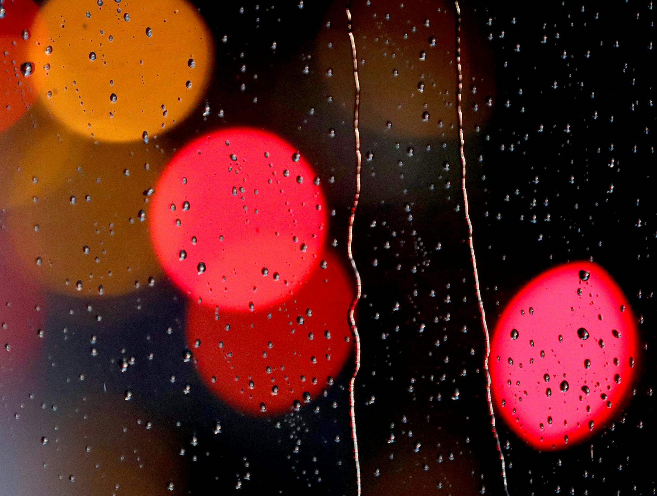 Traffic lights are seen through steady rain falling on a skyway window Wednesday, April 26, 2017, in downtown Minneapolis, MN. A cold, steady rain is forecast for Wednesday.] DAVID JOLES ï david.joles@startribune.com Steady, cold rain Wednesday