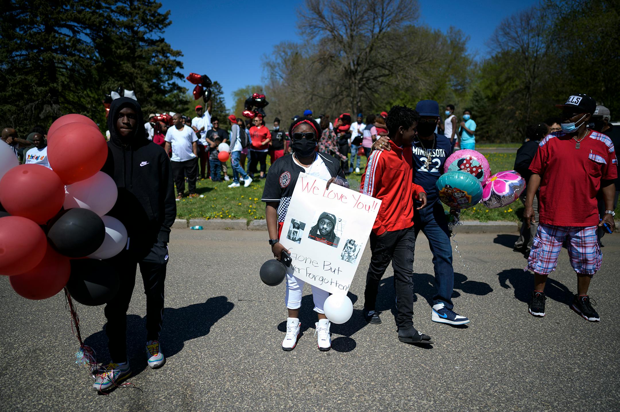 Brittany Lee, niece of Douglas Lewis, held a poster with photos of her uncle Doug during a memorial for Lewis Sunday afternoon. A memorial was held for Lewis, who was shot and killed Friday night, on Sunday, May 3, 2020 at the Burns Avenue Scenic Overlook in St. Paul, Minn.