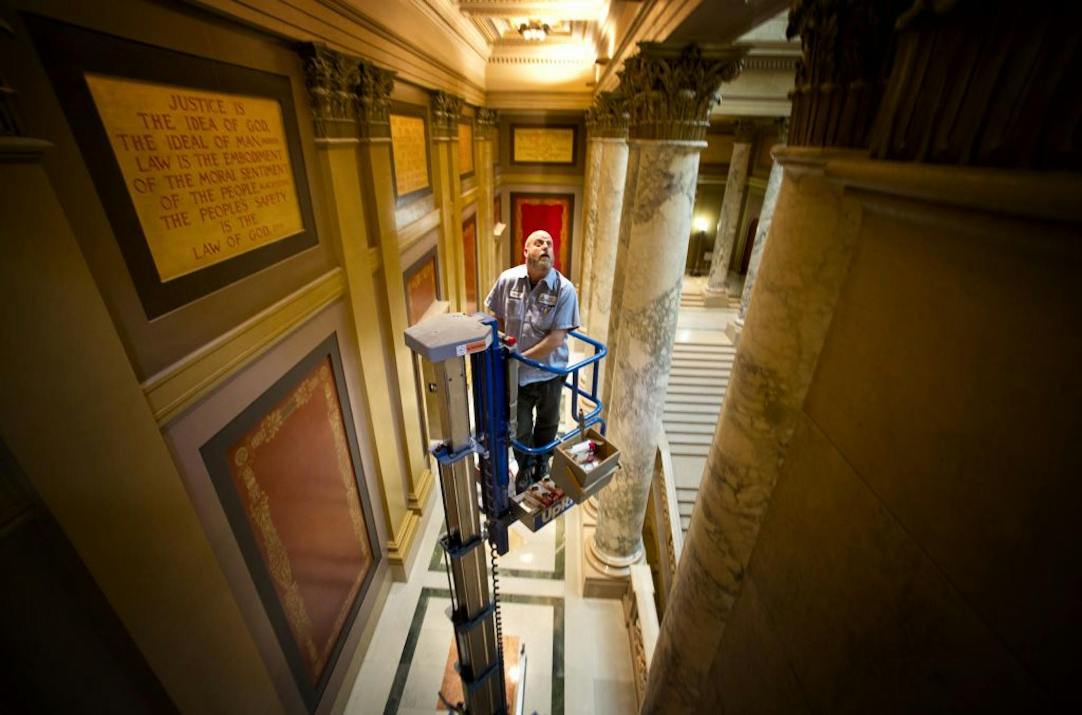 Dave Albien checked out light bulbs at the State Capitol on Monday, ahead of ­Tuesday's opening of the 2013 legislative session.