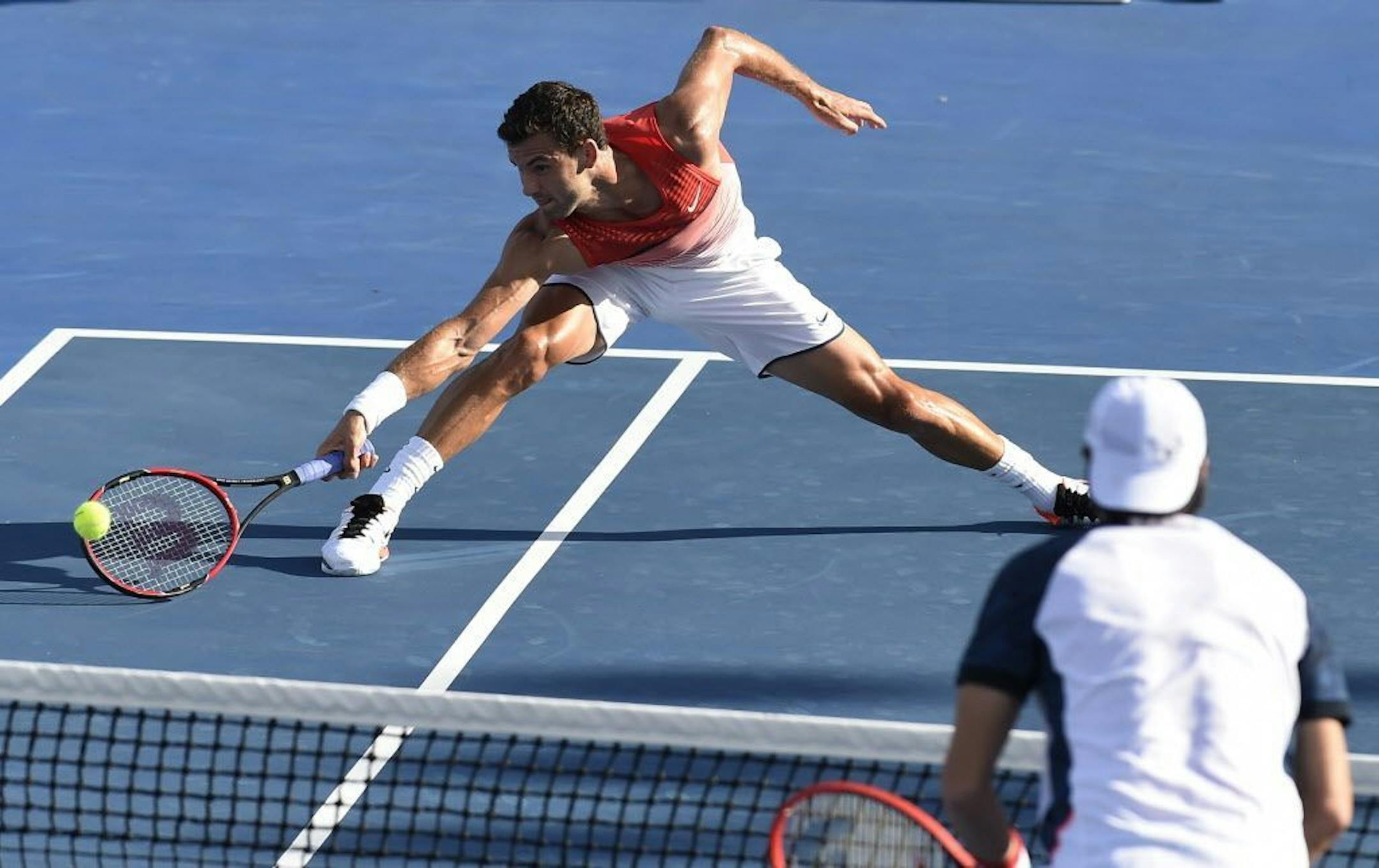 Grigor Dimitrov of Bulgaria makes a forehand return to Paolo Lorenzi of Italy during their first round match at the Australian Open tennis championships in Melbourne, Australia, Monday, Jan. 18, 2016.