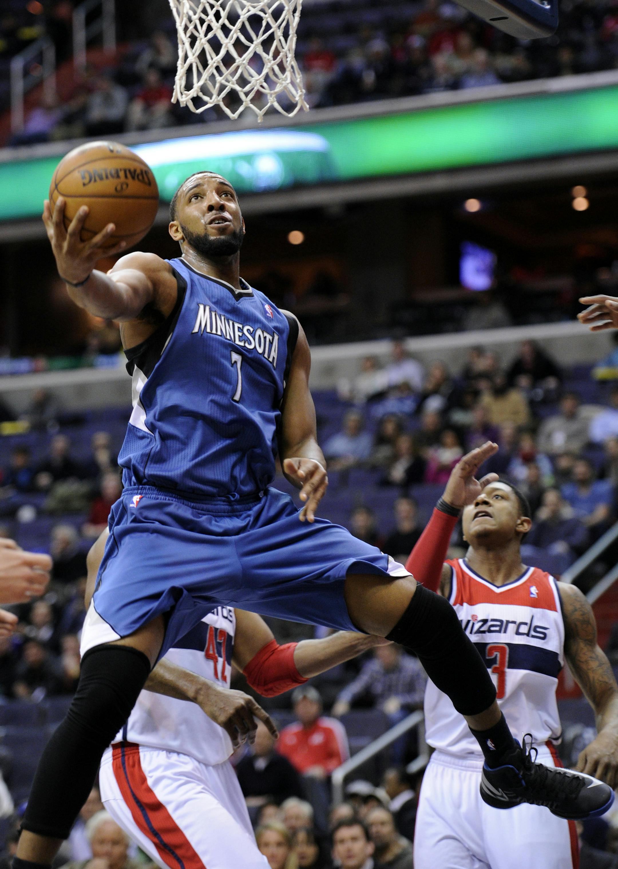 Minnesota Timberwolves forward Derrick Williams (7) goes to the basket against Washington Wizards guard Bradley Beal (3) during the first half of an NBA basketball game on Friday, Jan. 25, 2013, in Washington. (AP Photo/Nick Wass) ORG XMIT: VZN103