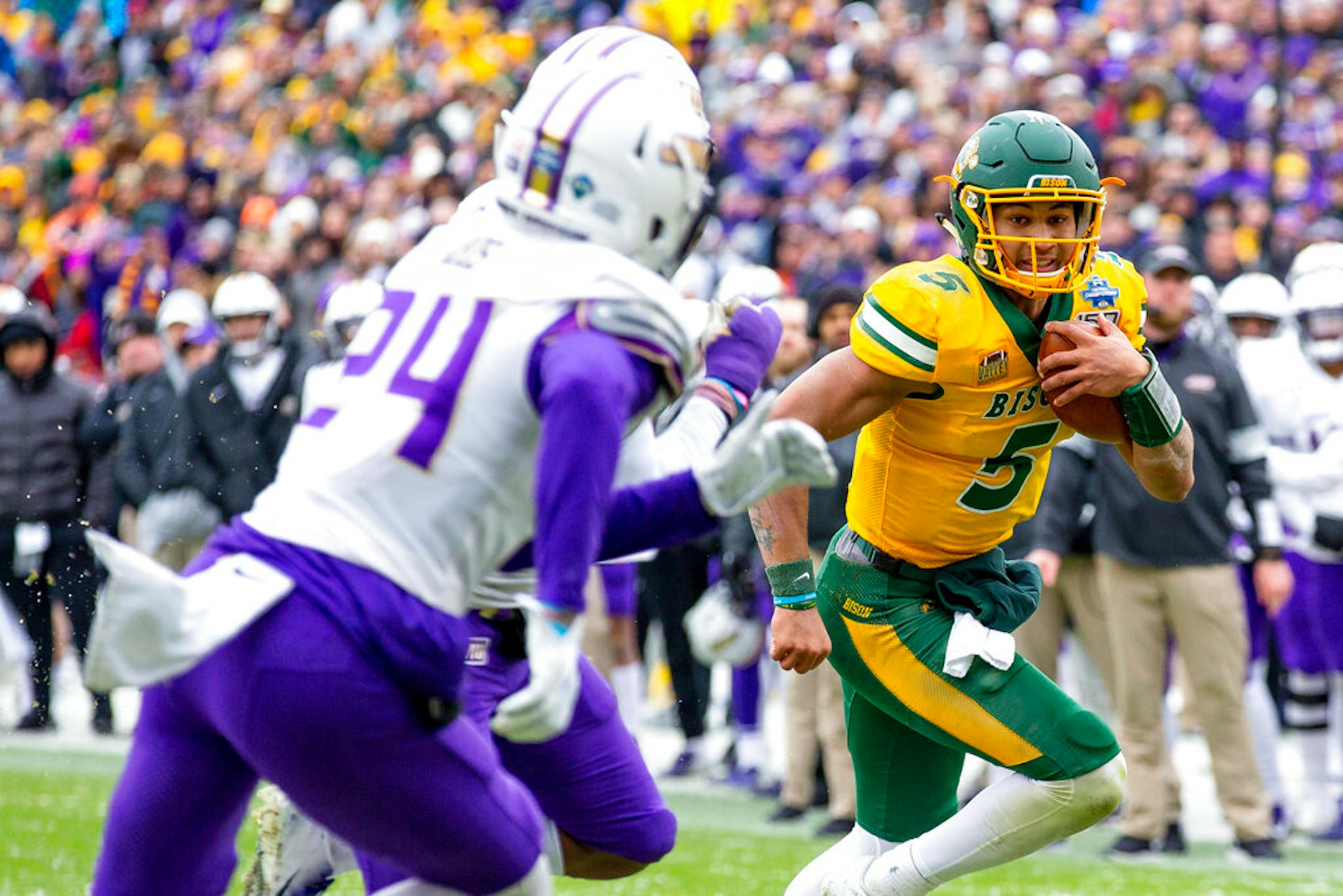 North Dakota State quarterback Trey Lance (5) runs the ball as James Madison safety D'Angelo Amos (24) pursues during the first half of the FCS championship NCAA college football game, Saturday, Jan. 11, 2020, in Frisco, Texas. (AP Photo/Sam Hodde)