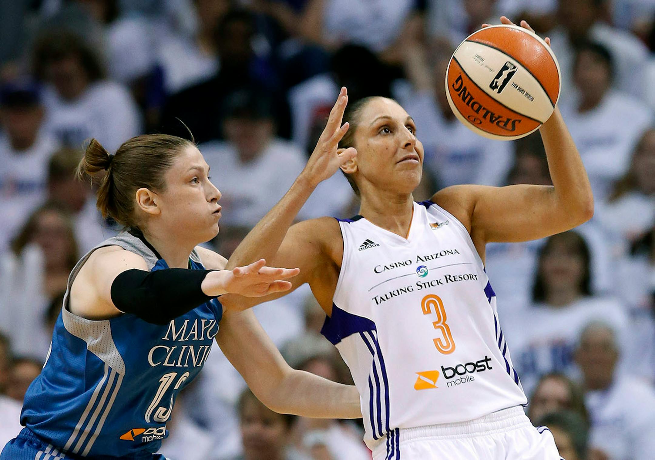 Phoenix Mercury's Diana Taurasi (3) tries to keep the ball away from Minnesota Lynx's Lindsay Whalen, left, during the first half in Game 1 of the WNBA Western Conference Finals basketball game, Friday, Aug. 29, 2014, in Phoenix. (AP Photo/Ross D. Franklin)