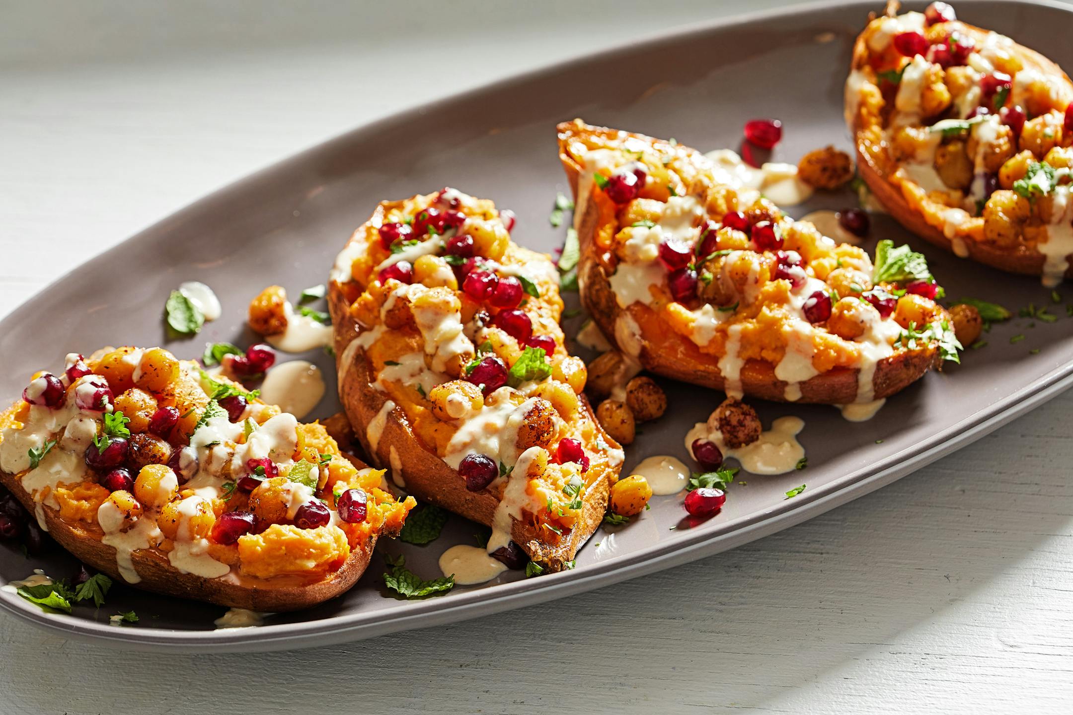 Spiced Tahini Loaded Sweet Potatoes. MUST CREDIT: Photo by Tom McCorkle for The Washington Post.