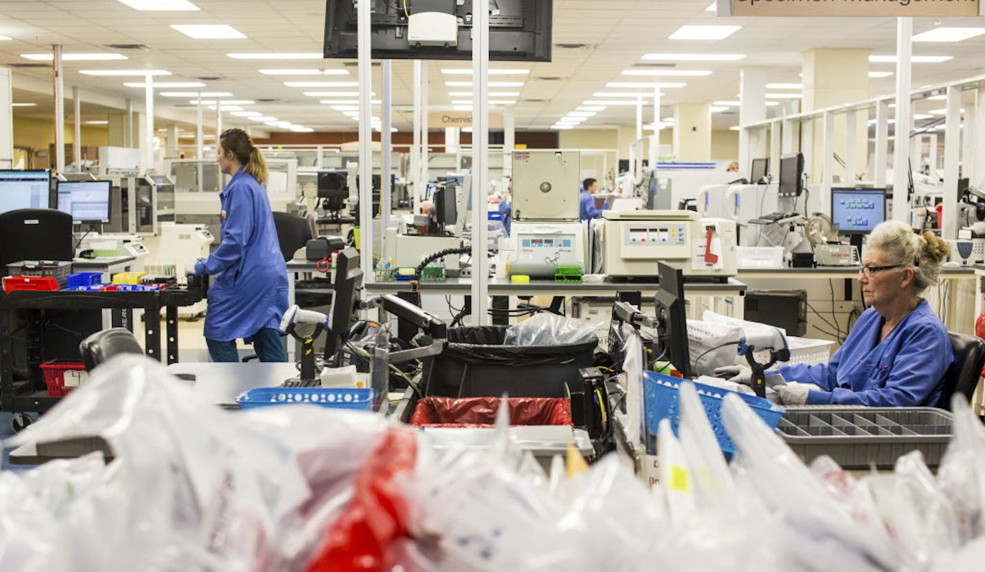 In this Dec. 20, 2016 photo, clinicians work at Allina Health's full service clinical testing lab in Minneapolis. (Evan Frost/Minnesota Public Radio via AP)