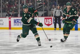 Minnesota Wild defenseman Brock Faber (7) takes a shot on goal in the first period.