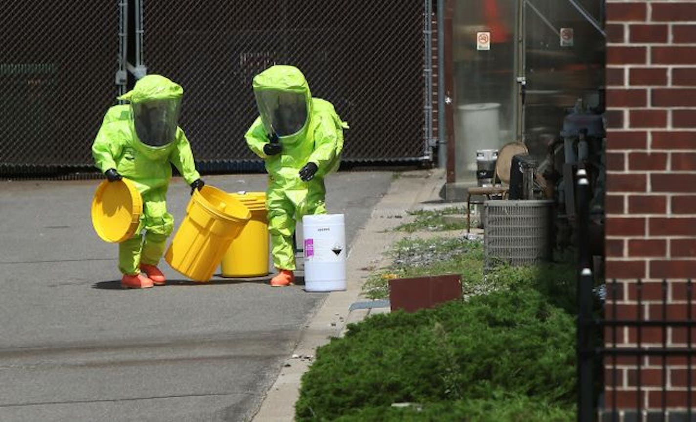 Hazardous materials crew contains the chemical spill that occurred at the Crowne Plaza Hotel in Eagan.