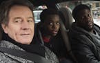 This image released by STXfilms shows Bryan Cranston, from left, Jahi Di'Allo Winston, and Kevin Hart in a scene from "The Upside." (David Lee/STXfilm