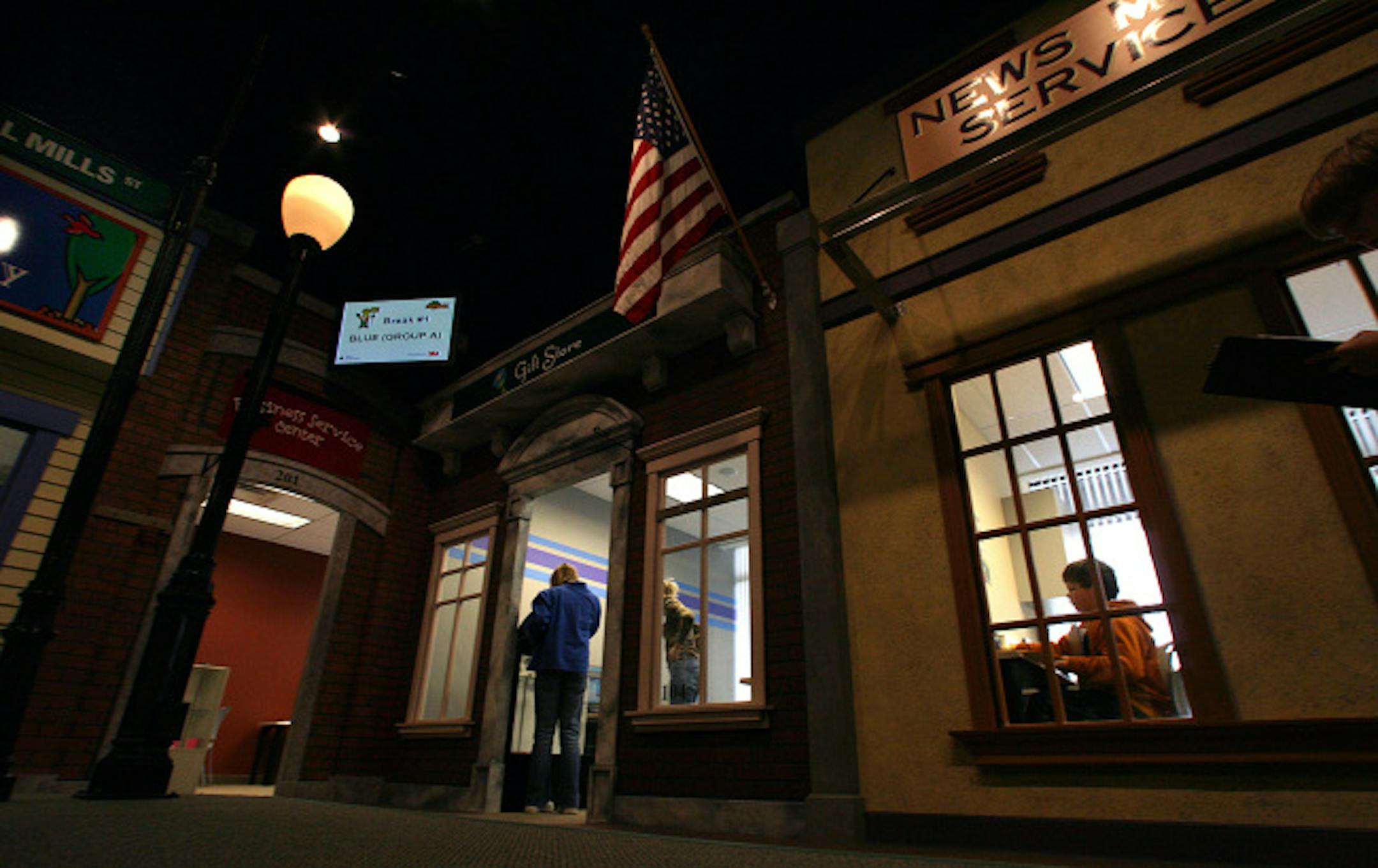 St. Anthony Middle School sixth grade student and editor Toby Bergum is framed in the window of the JA Biz Town newspaper as he works to put out the days news. About 70 students from the middle school gained work experience by working in the miniature community that features 14 businesses.