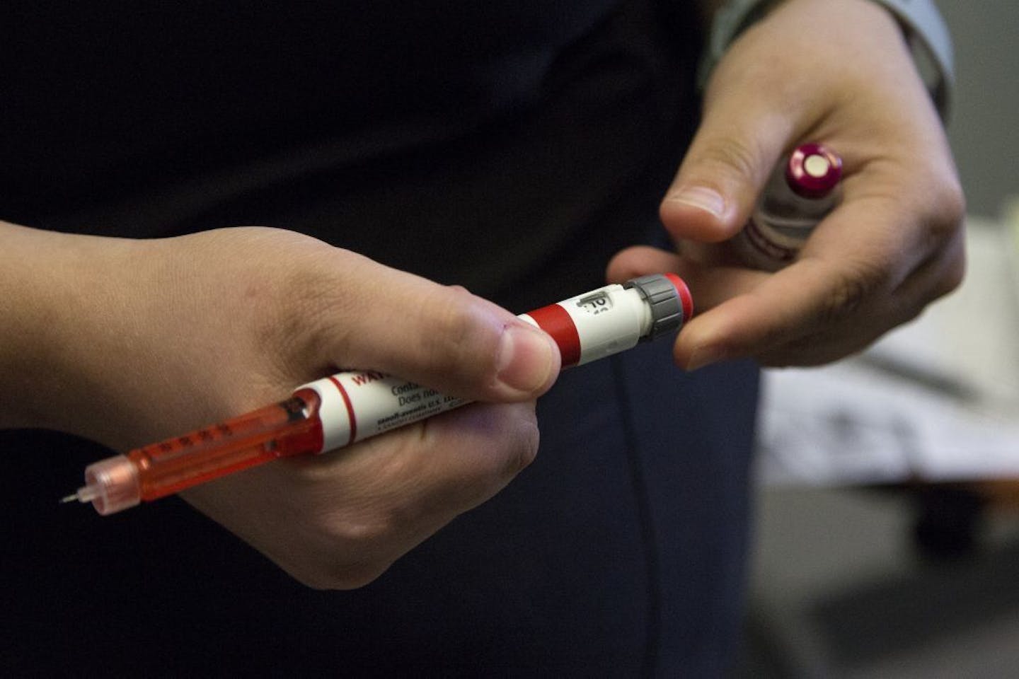 In this Wednesday, Aug. 21, 2019 photo, a nurse shows how to change the dosage on an insulin pen at the family practice Primary Care Specialists in Norfolk, Va. Without insurance, a 30-day supply of insulin pens can cost several hundred dollars. The cost of insulin in the U.S. has roughly tripled in recent years, putting pressure on people who are low-income or uninsured to pay for medication.