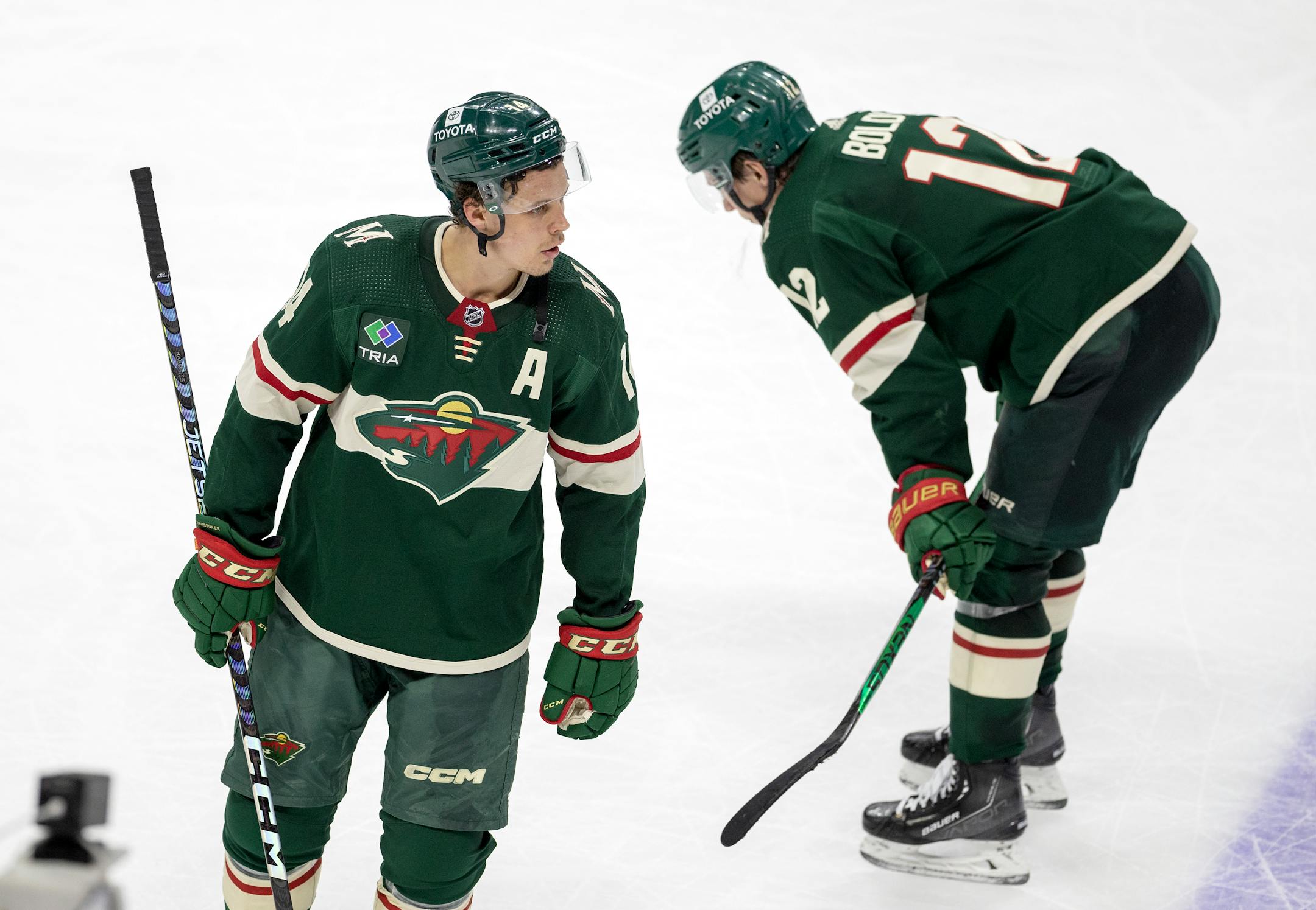 Joel Eriksson Ek (14) and Matt Boldy (12) of the Minnesota Wild at the end of the game.