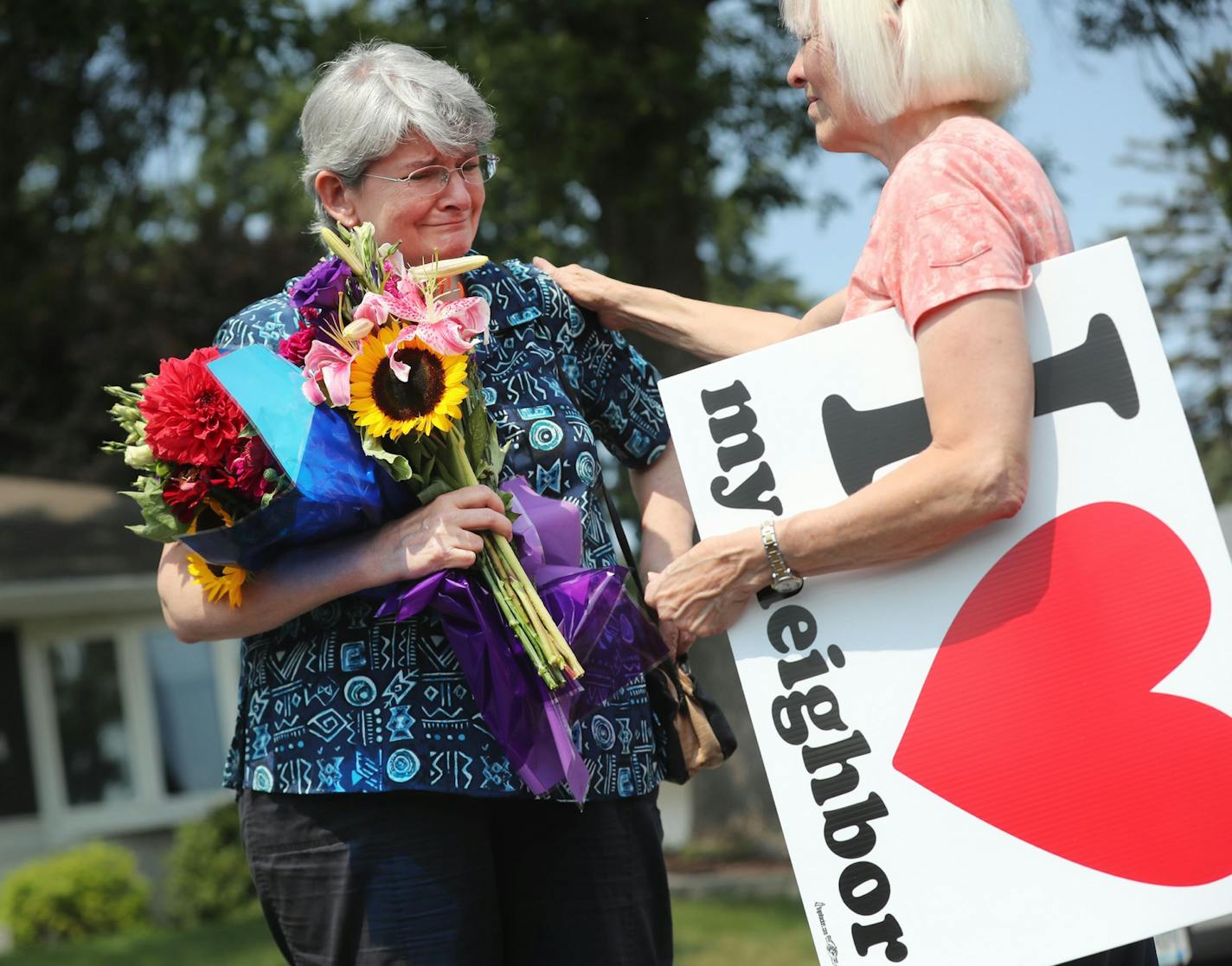 Police and federal authorities are investigating an early morning explosion Saturday at the Dar Al Farooq Islamic Center in Bloomington. Karen Willis of Bloomington brought flowers to the site and was clearly saddened as Candy Hazen, also of Bloomington, leaned in to hug her. They were among many who came in the site to offer support.