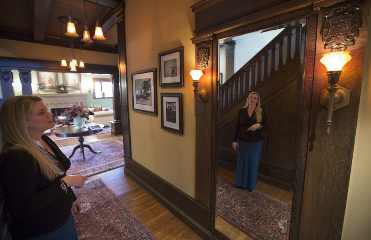 Real estate agent Jennifer Kirby looks at some of the ornate detail throughout Mark Perrin's Minneapolis mansion, which he has been trying to sell for five years.