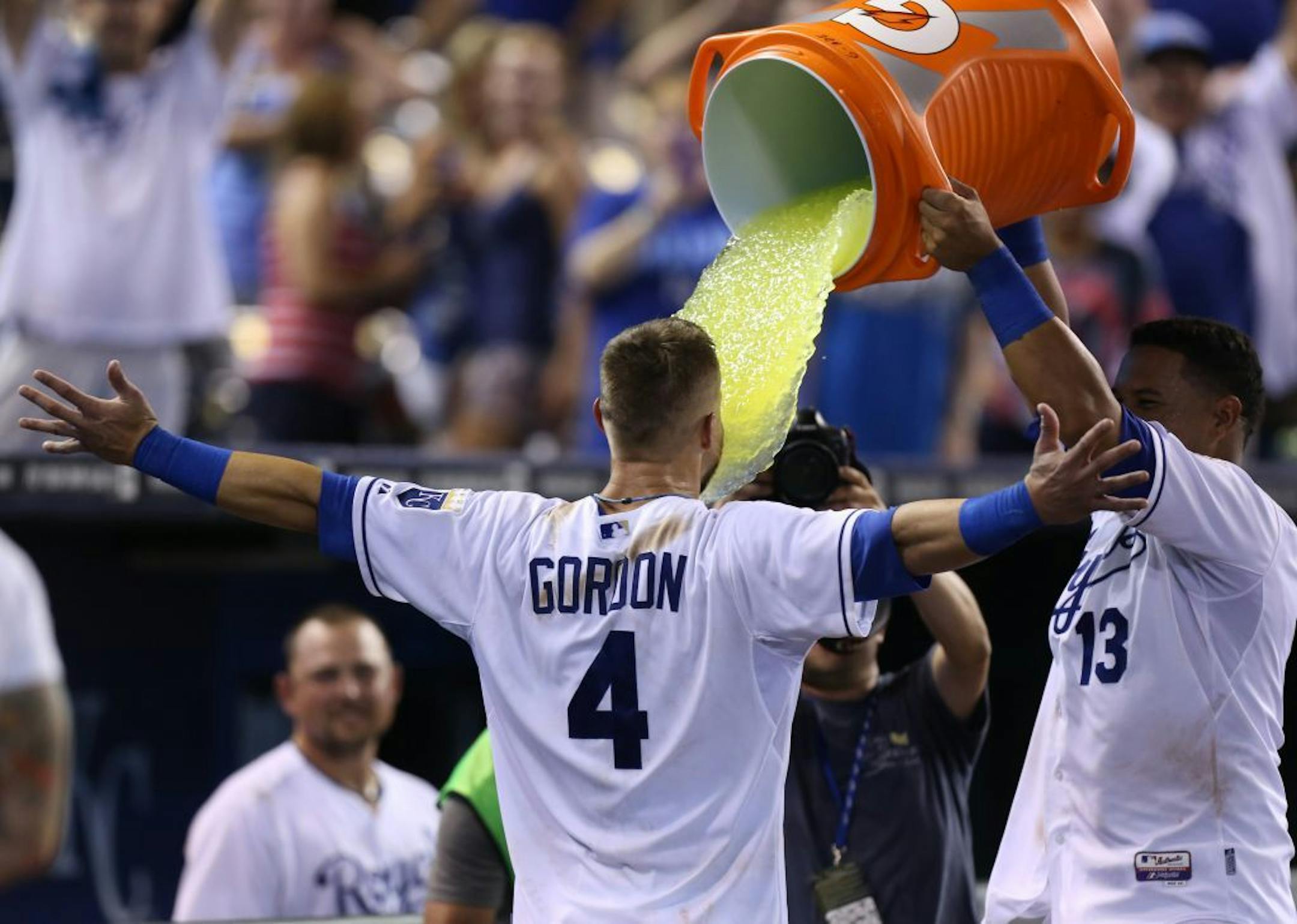 Kansas City Royals' Alex Gordon (4) is doused with Gatorade by Salvador Perez after Gordon hit a two-run walk-off home run against the Minnesota Twins during a baseball game Tuesday, Aug. 26, 2014, in Kansas City, Mo. The Royals won 2-1.