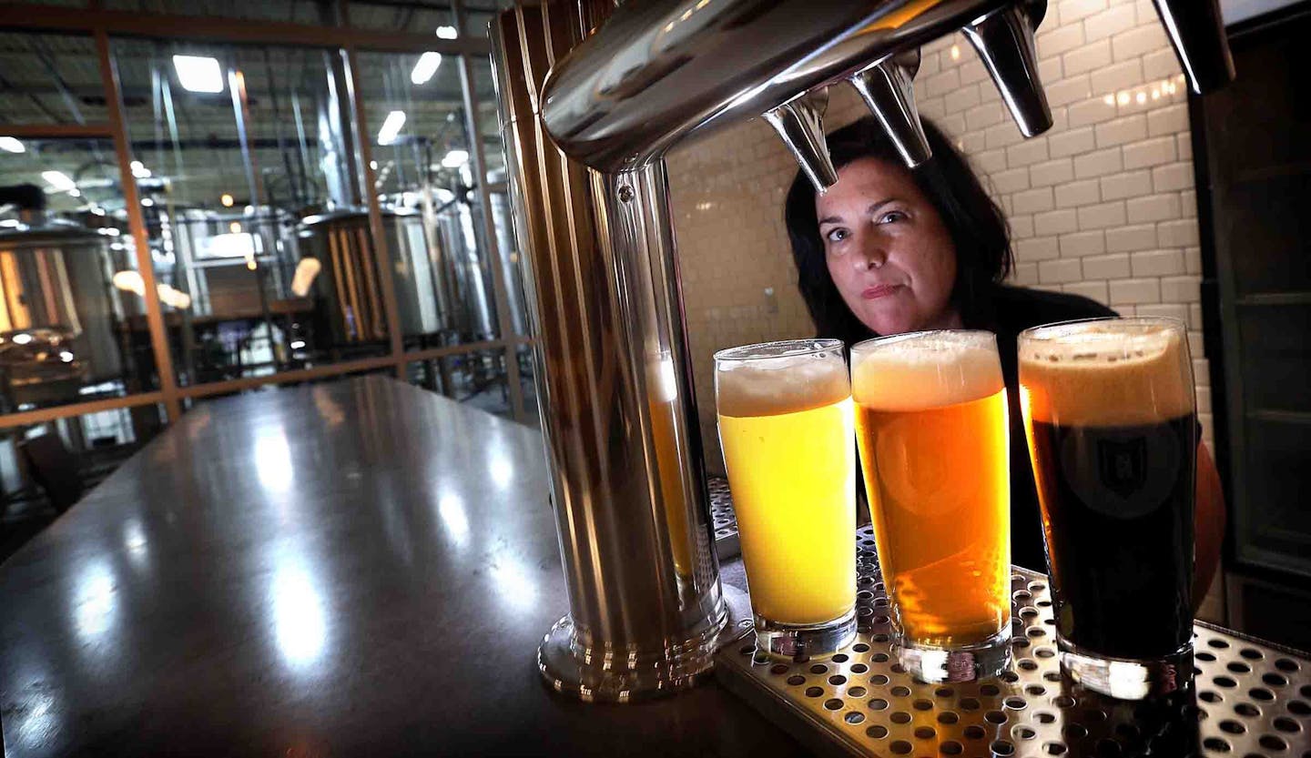 Brittany Krekelberg, a co-owner of the Badger Hill Brewing Company in Shakopee, displayed some of the company&#x201a;&#xc4;&#xf4;s brews in the new taproom. Brews from left are: White IPA (a gold medal winner); High Road Everyday Ale; andFourntain Stout. ] JIM GEHRZ &#x201a;&#xc4;&#xa2; james.gehrz@startribune.com / Shakopee, MN / December 11 2014 /11:00 AM - BACKGROUND INFORMATION: When Brittany Krekelberg and her husband were first dating, they toured Summit Brewing Company together. Both craf