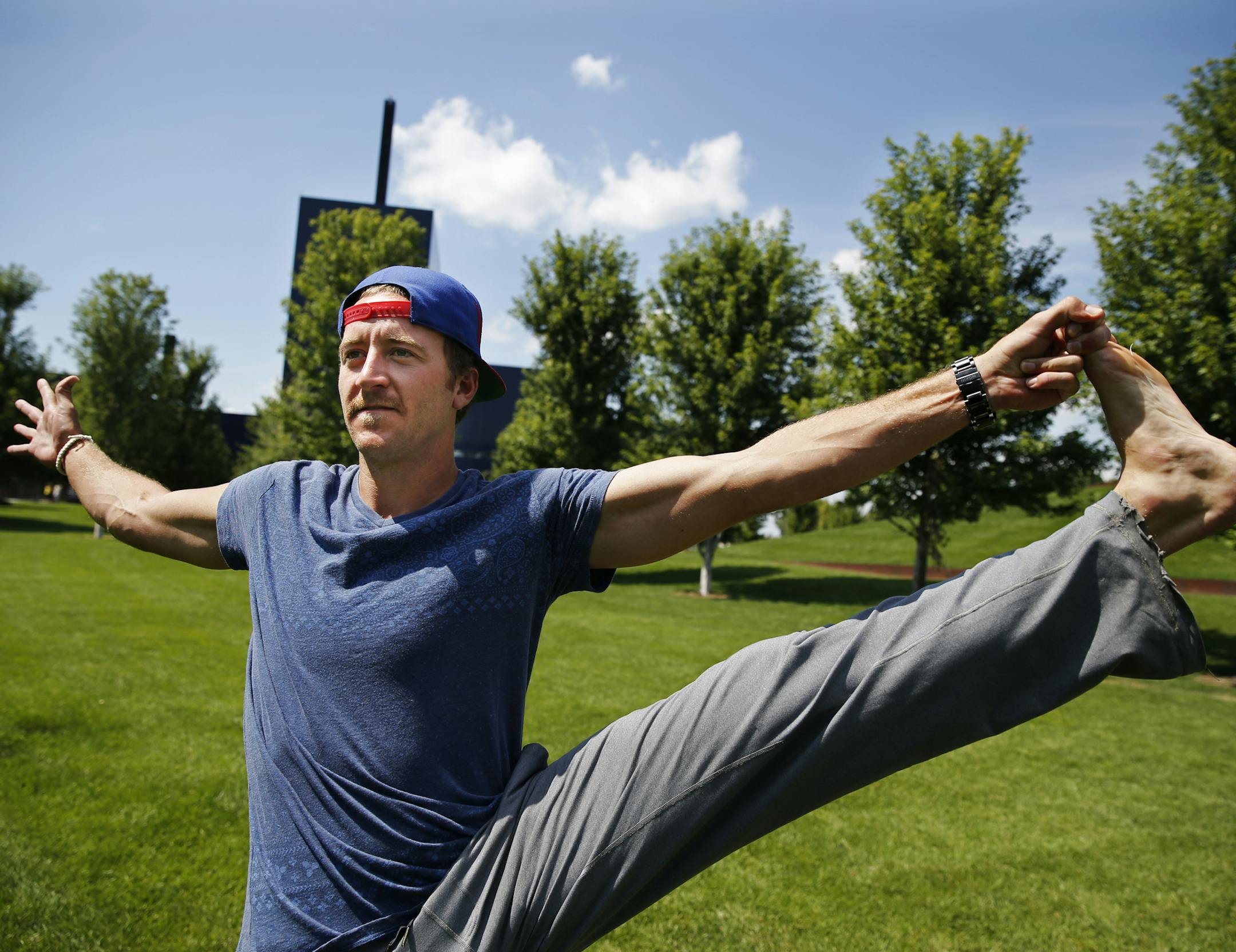 At Gold Medal Park, St. Paul Saints pitcher Mark Hamburger worked on yoga poses to give him better strength.