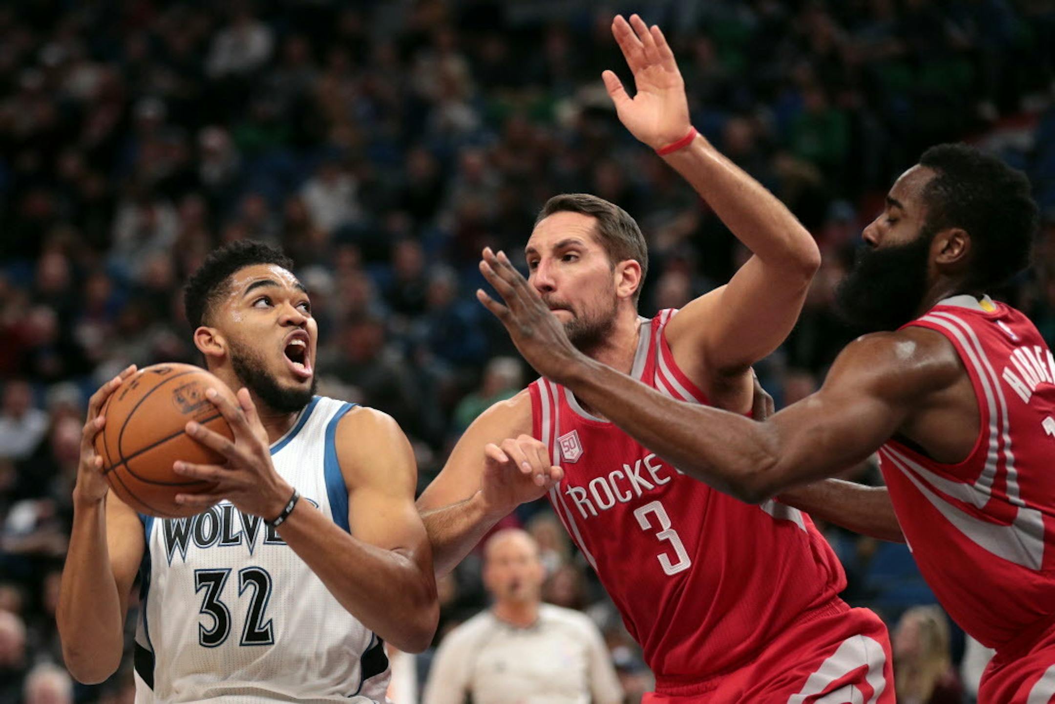 Minnesota Timberwolves center Karl-Anthony Towns (32) drives to the basket as Houston Rockets forward Ryan Anderson (3) and Houston Rockets guard James Harden (13) defend in the first half. ] ANTHONY SOUFFLE � anthony.souffle@startribune.com The Minnesota Timberwolves played the Houston Rockets during an NBA game Saturday, Dec. 17, 2016 at the Target Center in Minneapolis.