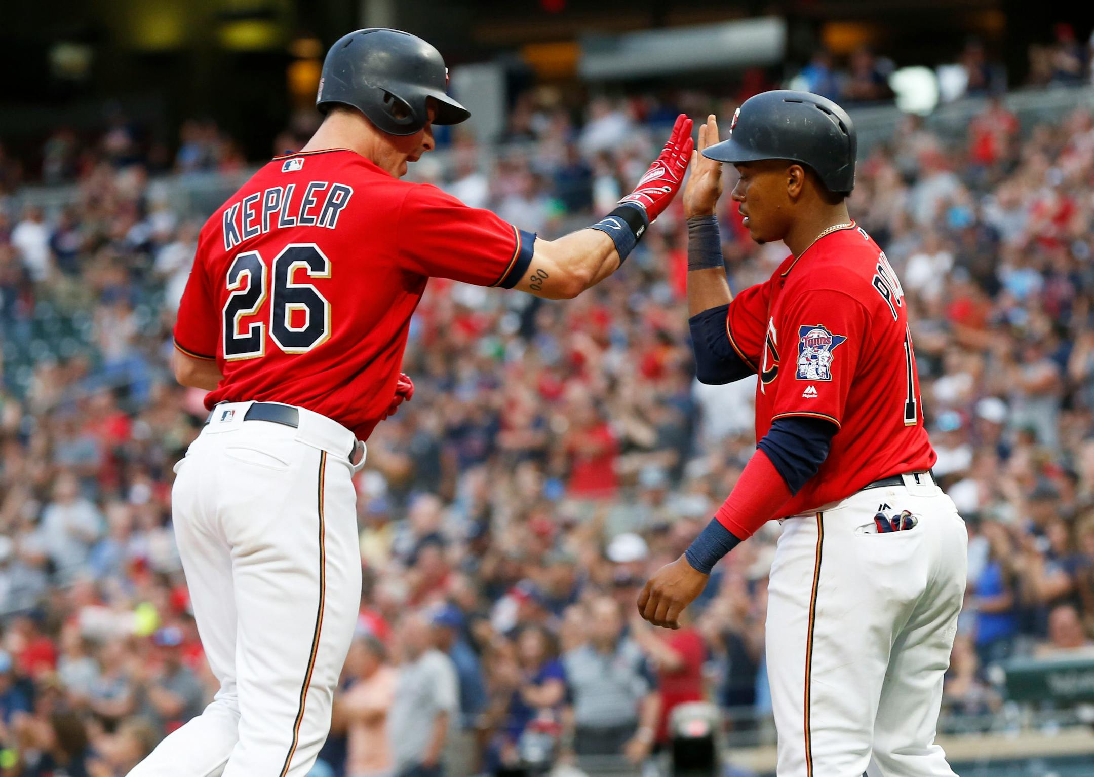 Max Kepler, left, and Jorge Polanco celebrate Kepler's two-run home run off Baltimore Orioles pitcher Dylan Bundy in the fourth inning