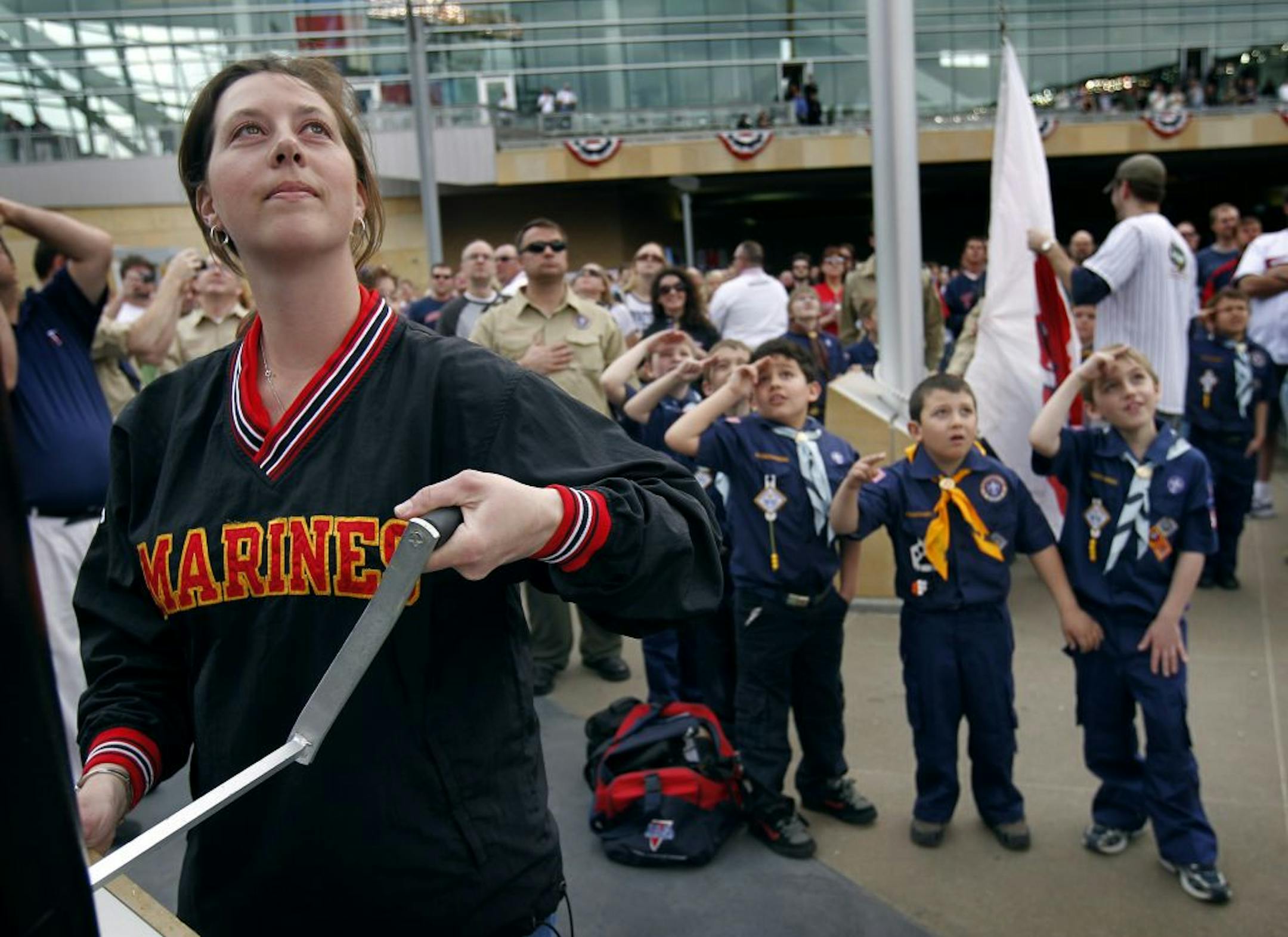 Sara Bodin raised the US flag at Target Field before the start of Sunday's Twins game at Target Field. Bodin is a former Marine helicopter crew chief. Members of Cub Scout Pack 112 raised the Twins Territory flag.