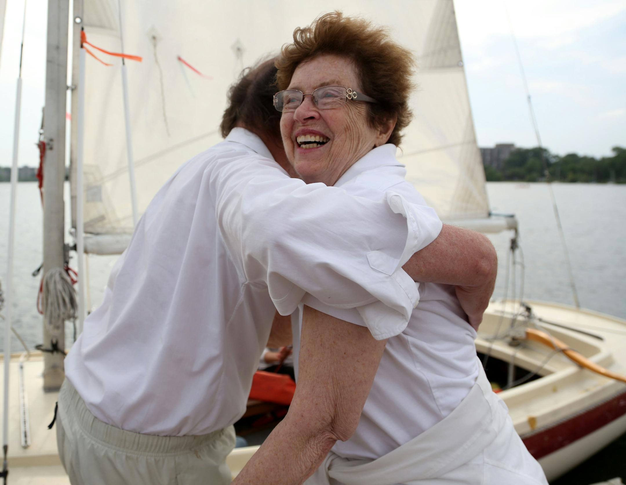 Werner Meybaum gave Polly Penney a hug after taking her on a trip around Lake Calhoun. ] (KYNDELL HARKNESS/STAR TRIBUNE) kyndell.harkness@startribune.com Werner Meybaum, a retired computer engineer who offers "almost free" rides on his sailboat. The almost free part? Riders have to be willing to sing, and one of Meybaum's favorite songs is "Itsy Bitsy Spider." at Lake Calhoun in Minneapolis Min. Thursday, June 26, 2014.