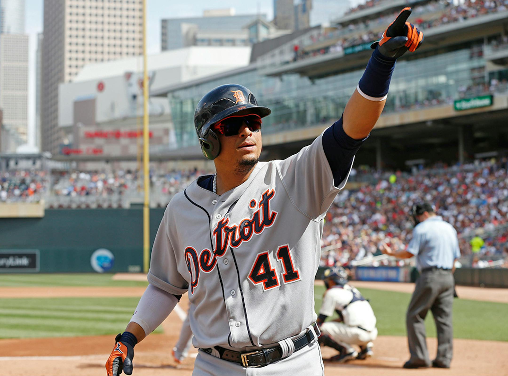 Detroit Tigers� Victor Martinez points to someone in the stands as he heads to the dugout following his solo home run off Minnesota Twins pitcher Phil Hughes in the fourth inning of a baseball game, Saturday, July 11, 2015, in Minneapolis.
