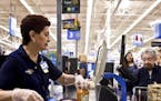 FILE &#xf3; Olga Aguirre checks out a customer at a Walmart Supercenter in North Bergen, N.J., Sept. 23, 2015. When Walmart announced in October that 